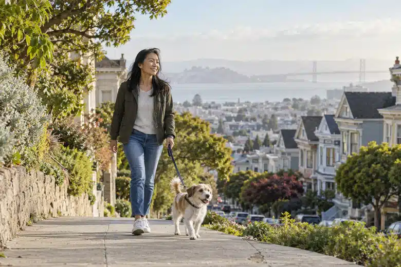 Woman walking a small dog on an illustrative San Francisco hillside